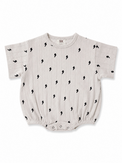 Light gray baby onesie with black lightning bolt print and short sleeves, featuring snap closure at the bottom.