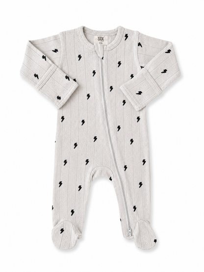 Light gray baby onesie with black lightning bolt pattern and zipper, featuring long sleeves and footed design.