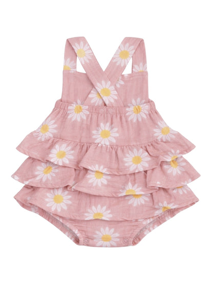 Pink floral baby romper with ruffled layers and cross-back straps, featuring white daisies and yellow centers.