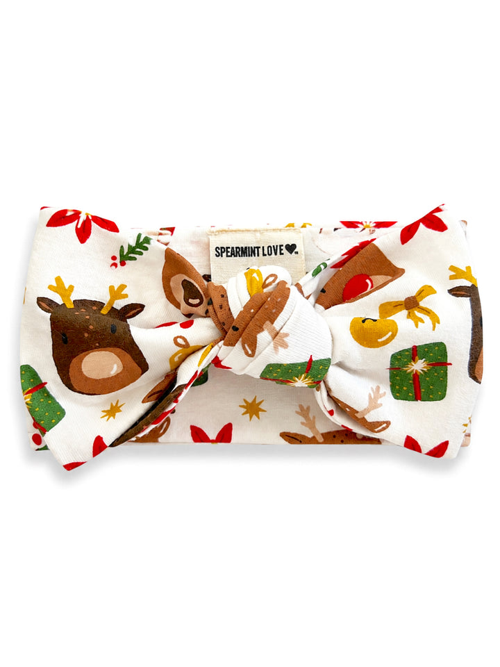 Holiday headband with deer and gift print, featuring a large bow and "Spearmint Love" label.