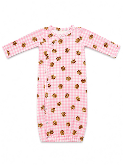 Pink gingham infant gown with teddy bear print and snap closures. Ideal for baby sleepwear.
