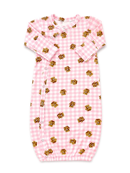 Pink gingham baby gown with teddy bear print, featuring snap buttons and elastic bottom for easy changing.