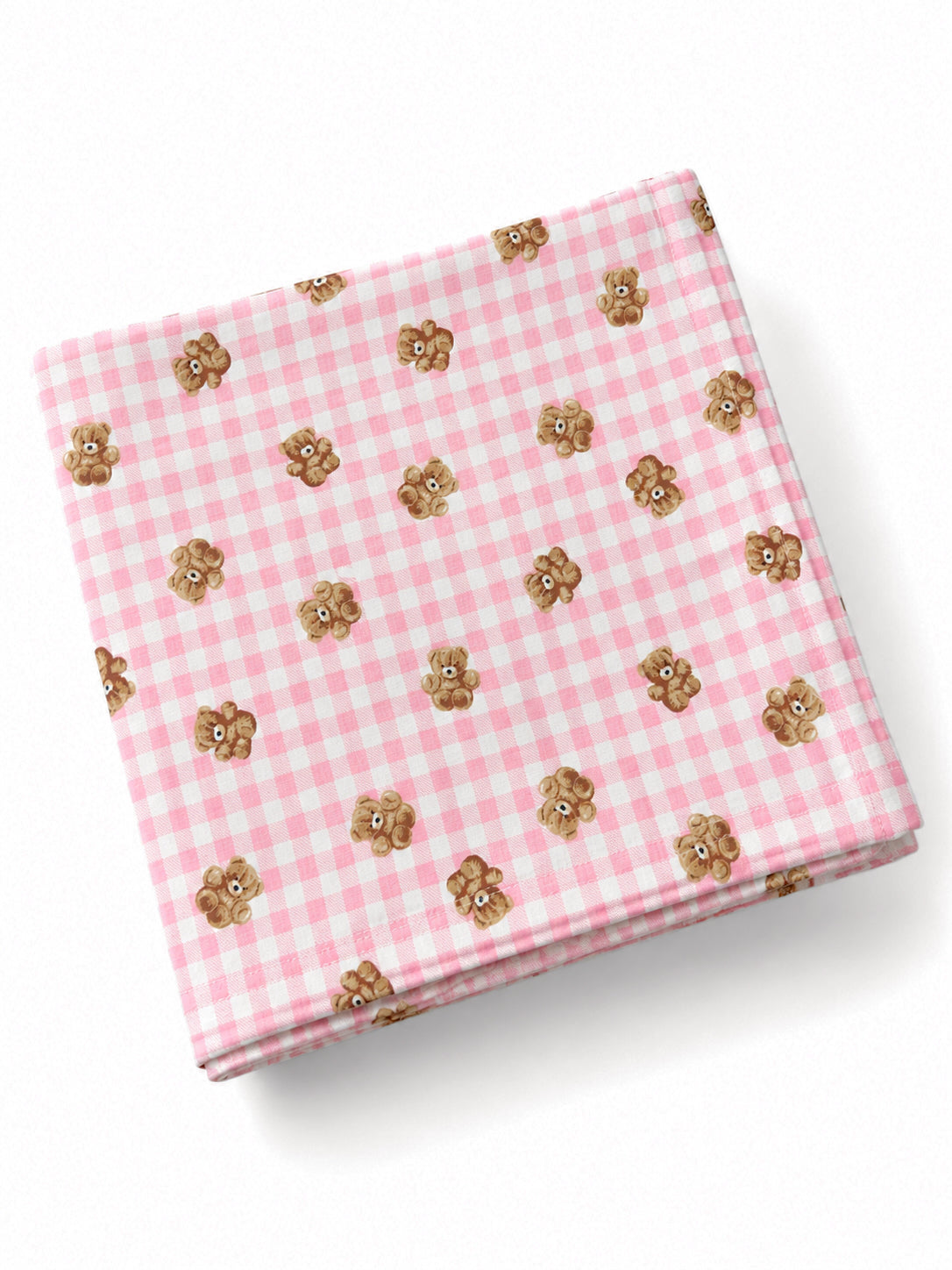 Pink gingham cloth with small teddy bear illustrations scattered across the fabric.