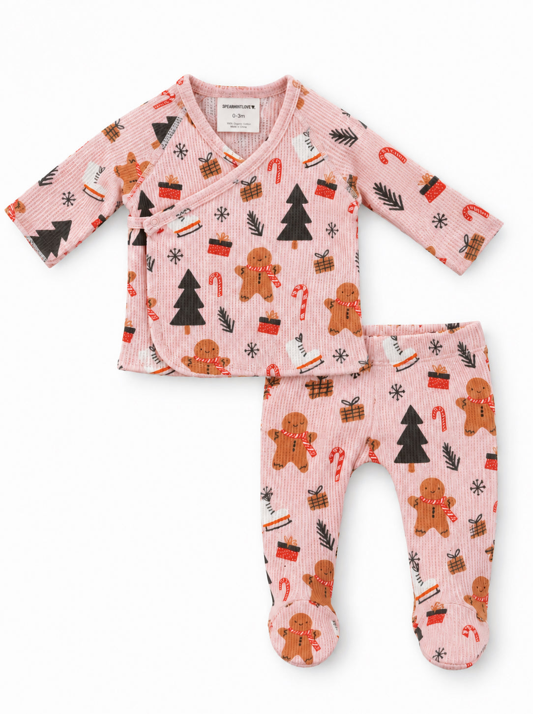 Baby pajama set featuring gingerbread men, candy canes, and Christmas trees on a pink background. Size 0-3 months.