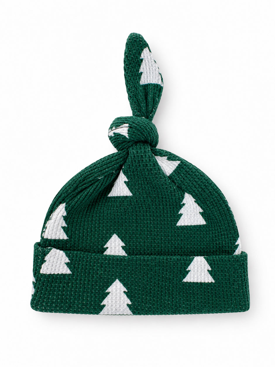 Green knit baby hat with white Christmas tree pattern and knot on top.