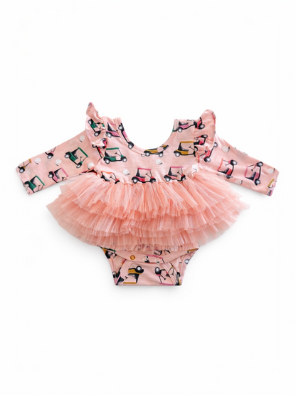 Pink ruffled dress with a frilly skirt and a playful vehicle pattern, perfect for young children.