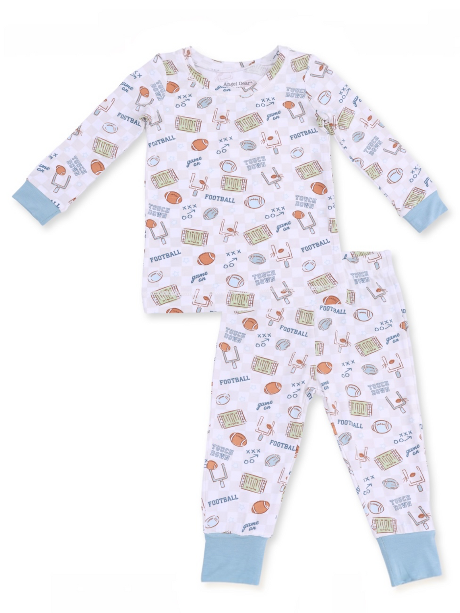 Children's pajama set featuring football-themed patterns and light blue cuffs.