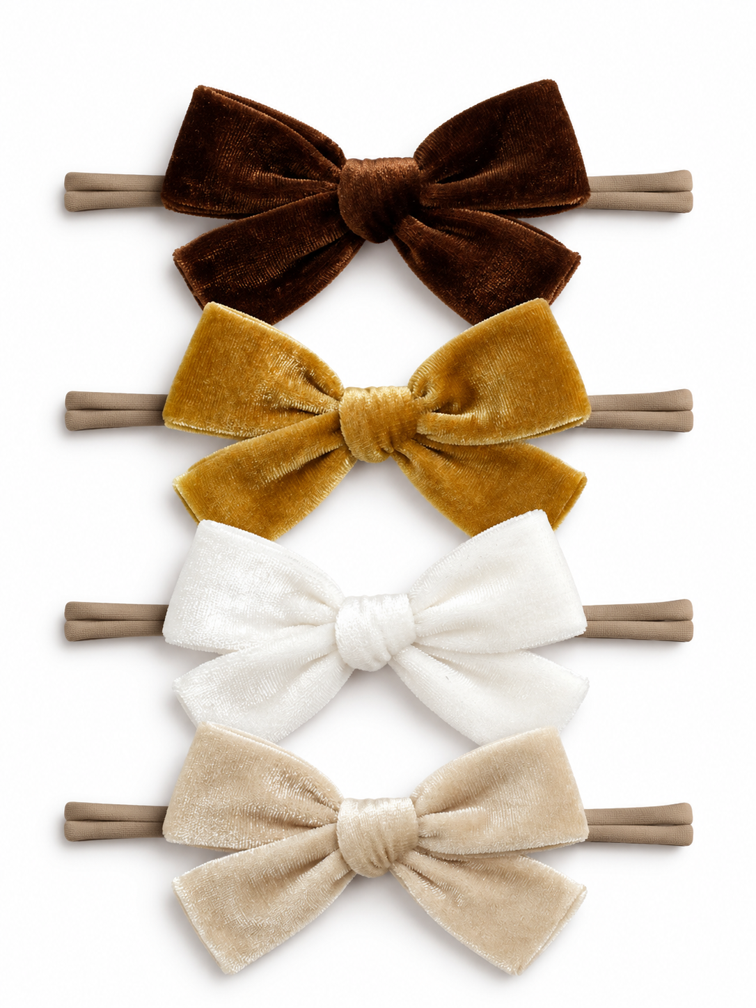 Set of four velvet hair bows in brown, gold, white, and beige on elastic bands.