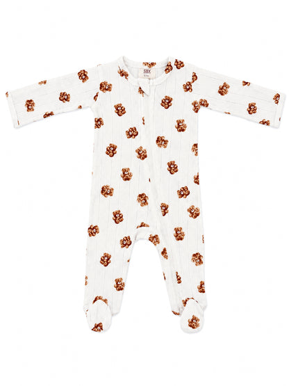 White baby sleeper with brown teddy bear print, featuring full sleeves and footed design.