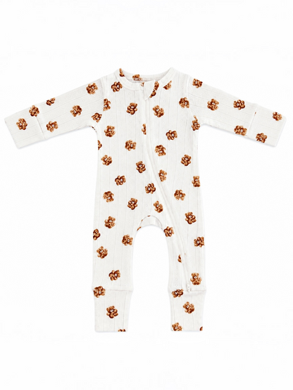 White baby onesie with brown floral print and long sleeves, featuring a front zip closure.
