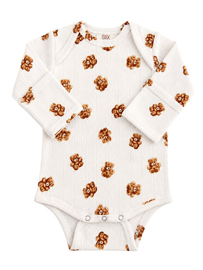 White baby onesie with teddy bear pattern on a textured background. Ideal for infants, cozy and stylish.