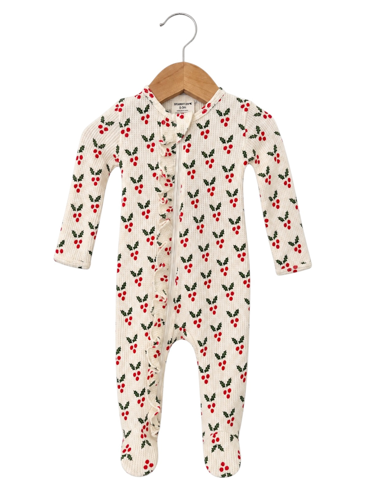 Cream baby onesie with red berry and green leaf pattern, featuring long sleeves and a ruffled front.