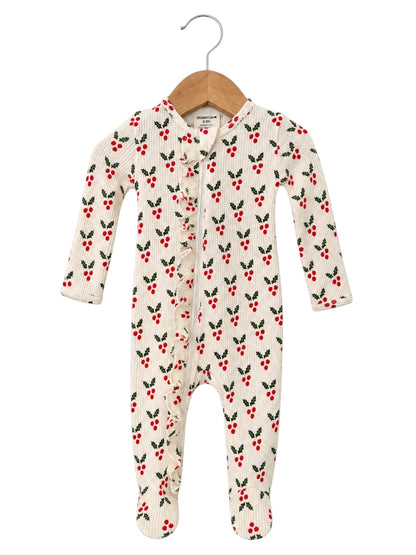 Cream baby onesie with red berry and green leaf pattern, featuring long sleeves and a ruffled front.