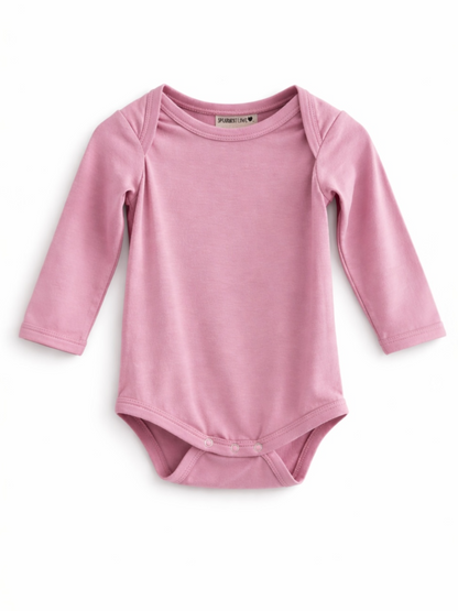 Light pink long-sleeve onesie with snap closure at the bottom, ideal for infants.