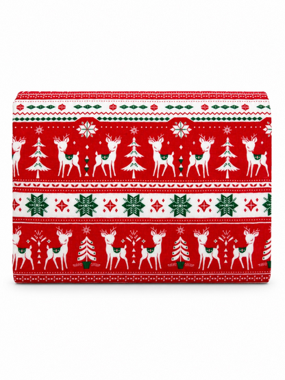 Red holiday fabric featuring white reindeer, green trees, and snowflakes in festive patterns.