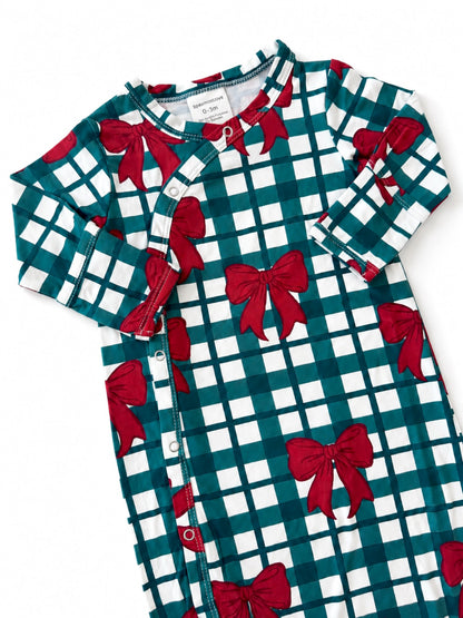 Green and white grid-patterned infant gown with red bows and snap closure.