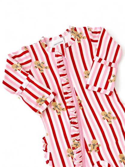 Child's red and pink striped romper with gingerbread cookie designs and ruffle details.