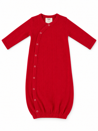 Red baby gown with long sleeves, snap buttons, and ribbed texture, suitable for infants 0-3 months.