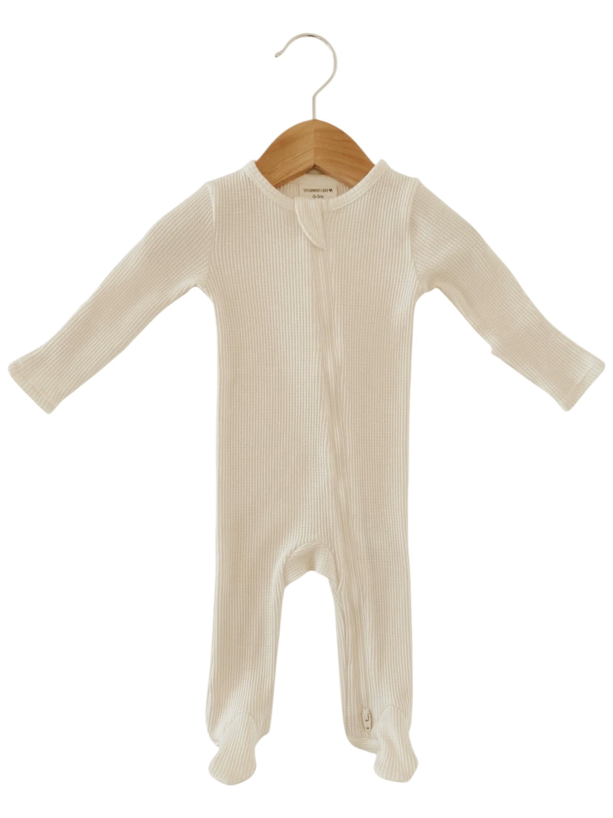 White ribbed baby onesie hanging on a wooden hanger.