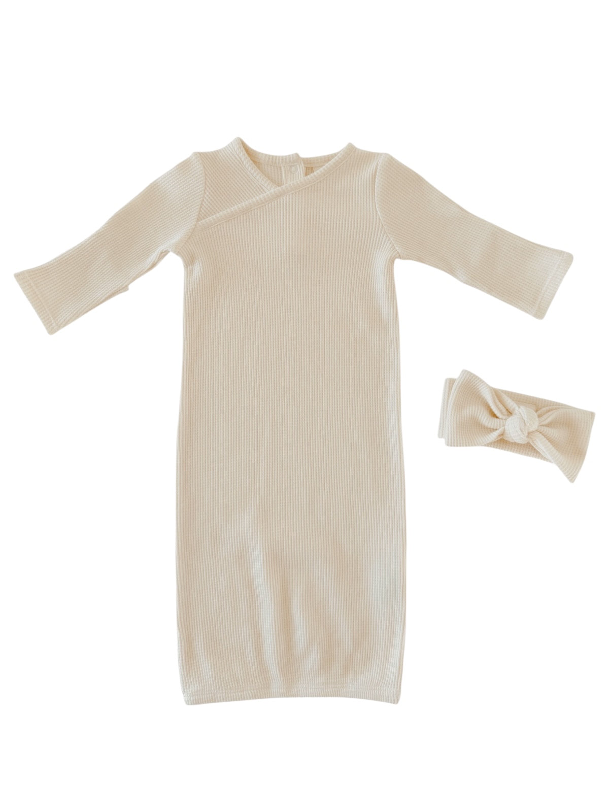 Cream-colored baby dress and matching headband set, featuring a ribbed texture and long sleeves.
