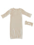 Cream-colored baby dress and matching headband set, featuring a ribbed texture and long sleeves.
