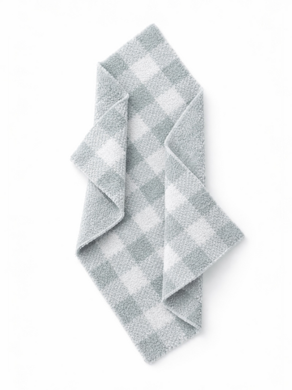 Gray and white checked dish towel folded on a white background. Ideal for kitchen use and decor.