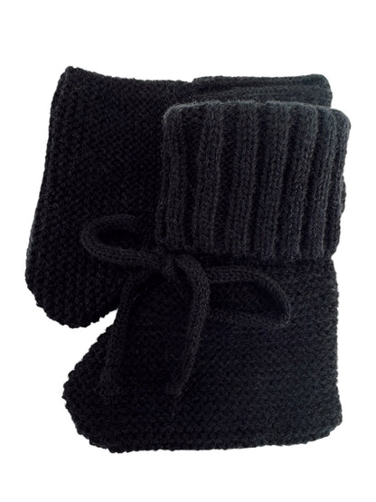 Black knitted slippers with a ribbed cuff and bow detail. Ideal for warmth and comfort at home.