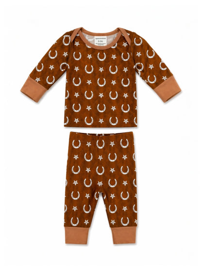 Brown baby pajamas with moon and star patterns, featuring long sleeves and matching pants.