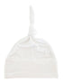 White baby hat with a knotted top and folded cuff, made of soft fabric.