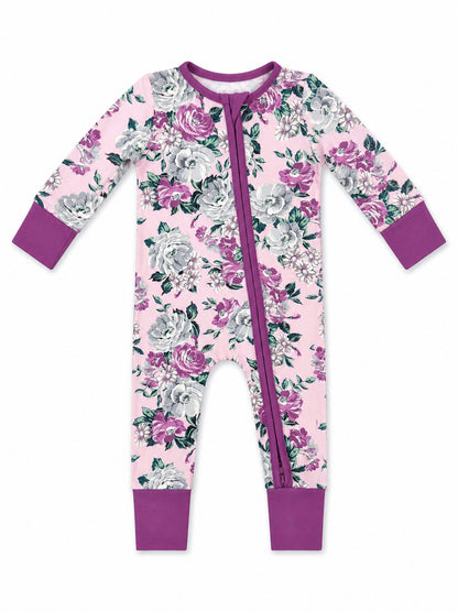 Floral baby onesie in pink with purple accents and zipper front, featuring roses and leaves design.
