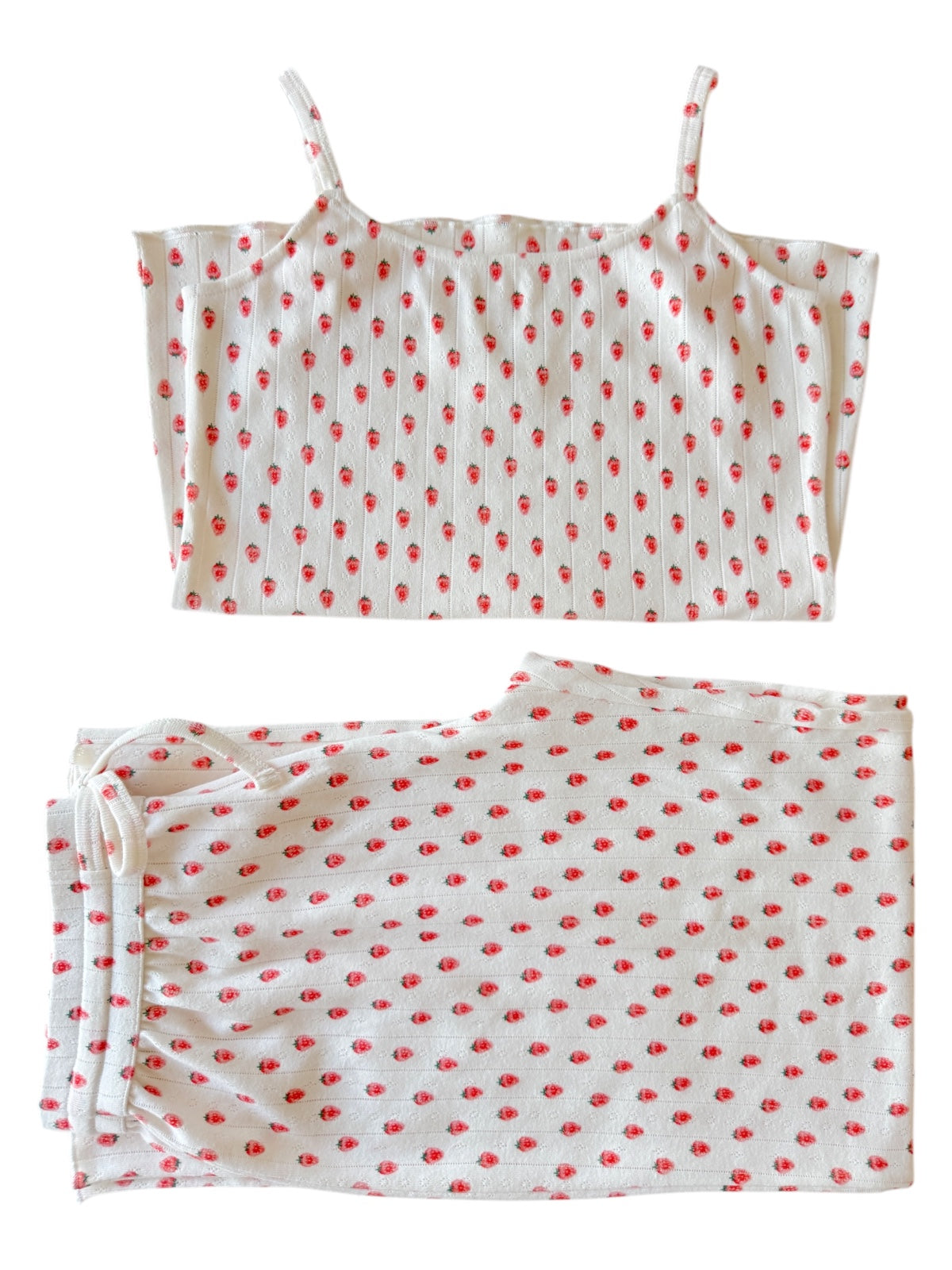 White pajama set with red floral pattern, featuring a cami top and matching drawstring pants.
