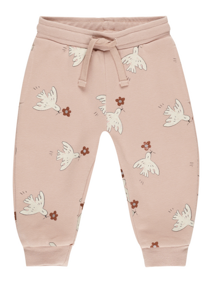 Pink children’s sweatpants featuring white birds and small floral patterns. Casual and comfy design.