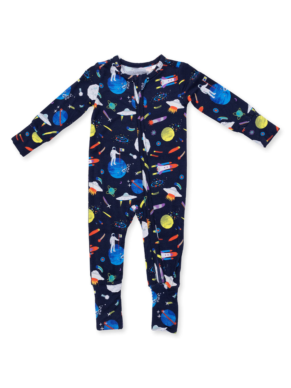 Navy blue pajama onesie with colorful space-themed prints of rockets, planets, and astronauts.
