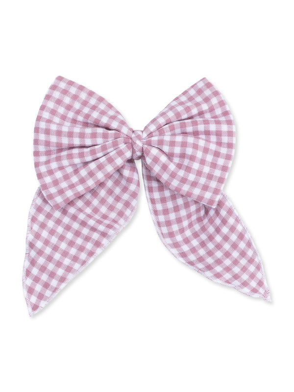 Pink gingham fabric bow with long tails, centered knot, on a white background. Ideal for hair accessories or decor.