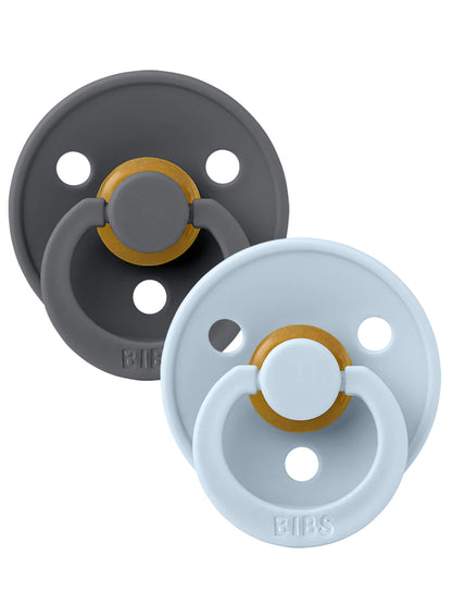 Two pacifiers in gray and light blue with round bases and golden rings. Ideal for infants.