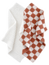 Two plush blankets: one white textured and one with a brown and white checkered pattern, layered together.