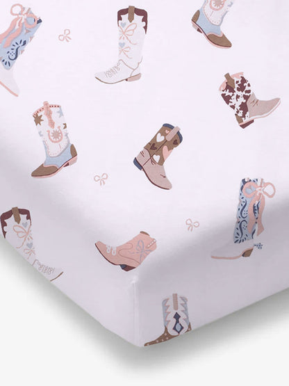 Patterned fabric featuring various illustrated cowboy boots on a light background.