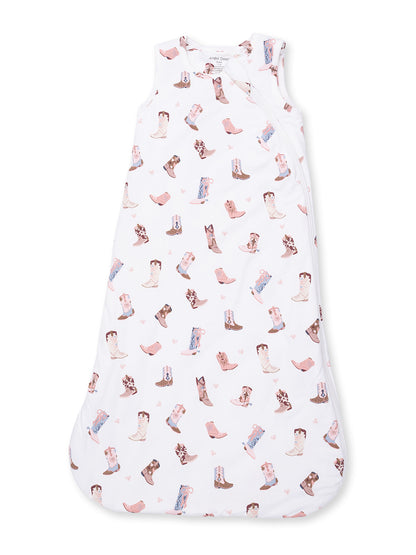 White baby sleeping sack with a playful cowboy boot pattern in soft pastel colors.