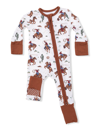 White baby onesie with cowboy print, featuring a front zipper and brown accents on cuffs and pockets.
