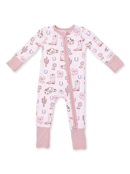 Pink infant pajamas with cowboy and cactus patterns, featuring long sleeves and a front zipper.