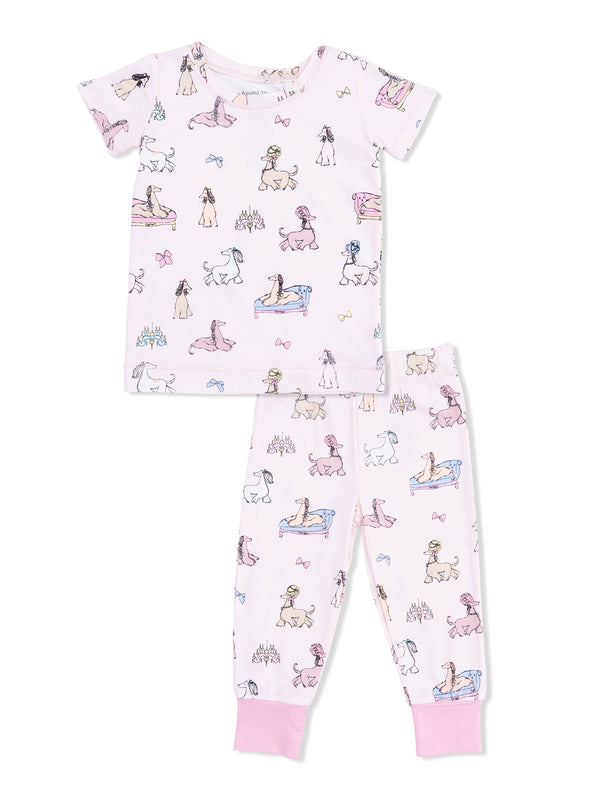Children's pajama set featuring playful dog illustrations on a soft pink background. Includes a short-sleeve top and pants.
