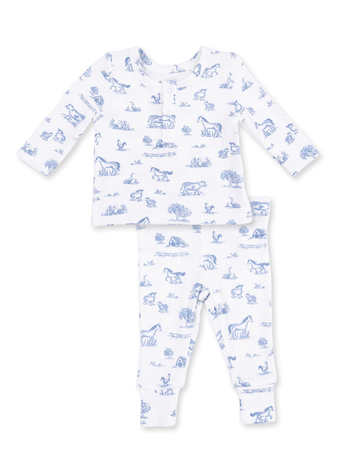 Blue and white children's pajama set featuring animal and nature illustrations on both top and pants.