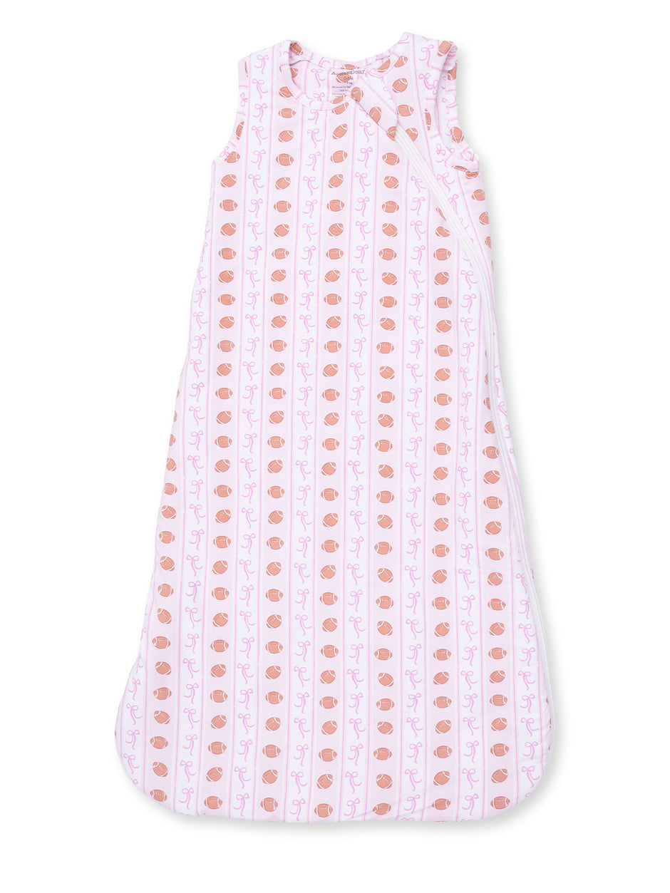 Light pink sleep sack with a pattern of cups and bows, perfect for infants and toddlers.