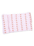 Pink fabric with football and ribbon pattern rolled neatly. Ideal for craft or sewing projects.