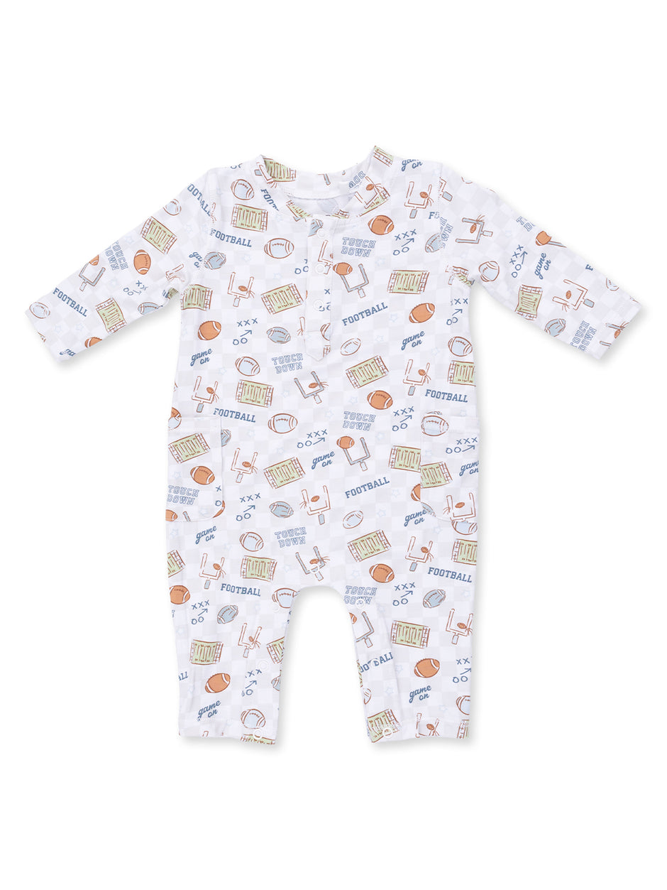 White baby romper with football-themed print including balls, goalposts, and the word "football."