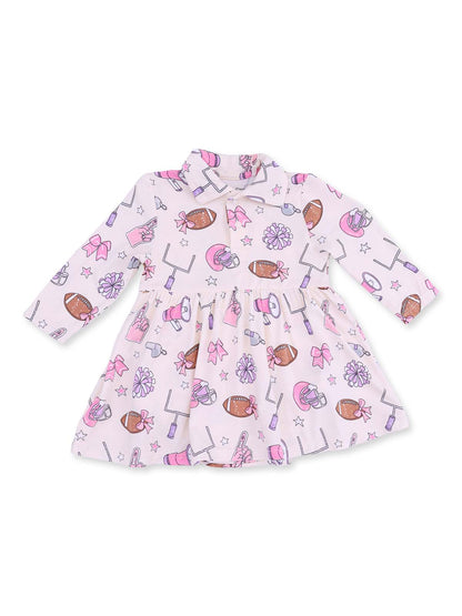 Pink dress with playful sports-themed patterns, including footballs, cheerleading bows, and pom-poms.