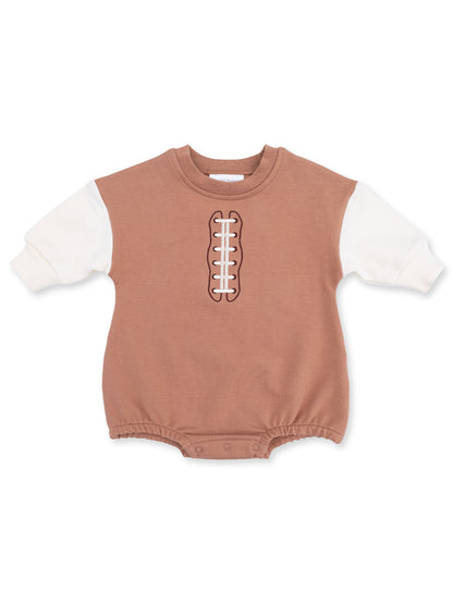 Brown baby onesie with white sleeves and football stitching design on the front. Perfect for sports fans.