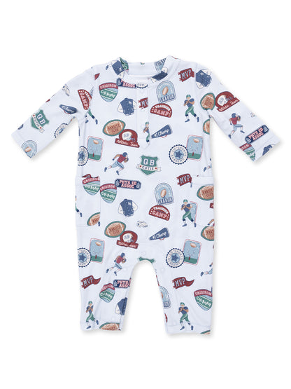 Infant onesie featuring a colorful sports-themed pattern with badges and illustrations of children playing sports.