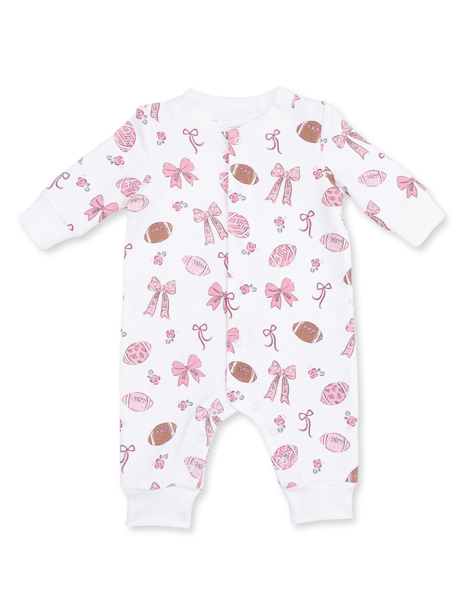 Pink football and bow patterned infant onesie on a white background.