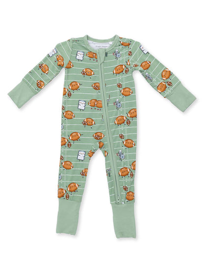 Green baby onesie with cartoon footballs and playful characters on a striped background.